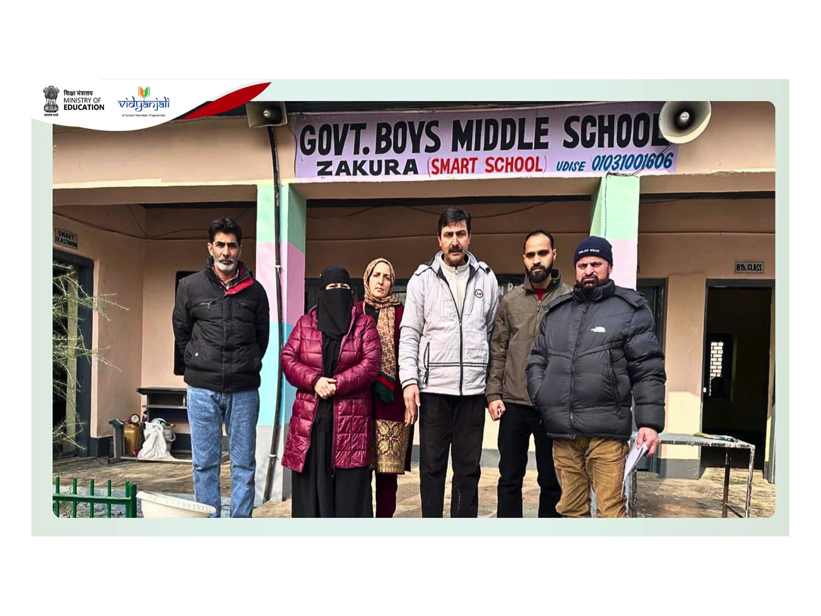 Teachers and volunteers pose outside Govt Boys Middle School, Zakura (Smart School), in Srinagar district, Jammu and Kashmir, as part of Vidyanjali-supported efforts to strengthen government schools through infrastructure upgrades and digital learning. (Image Source: Ministry of Education)