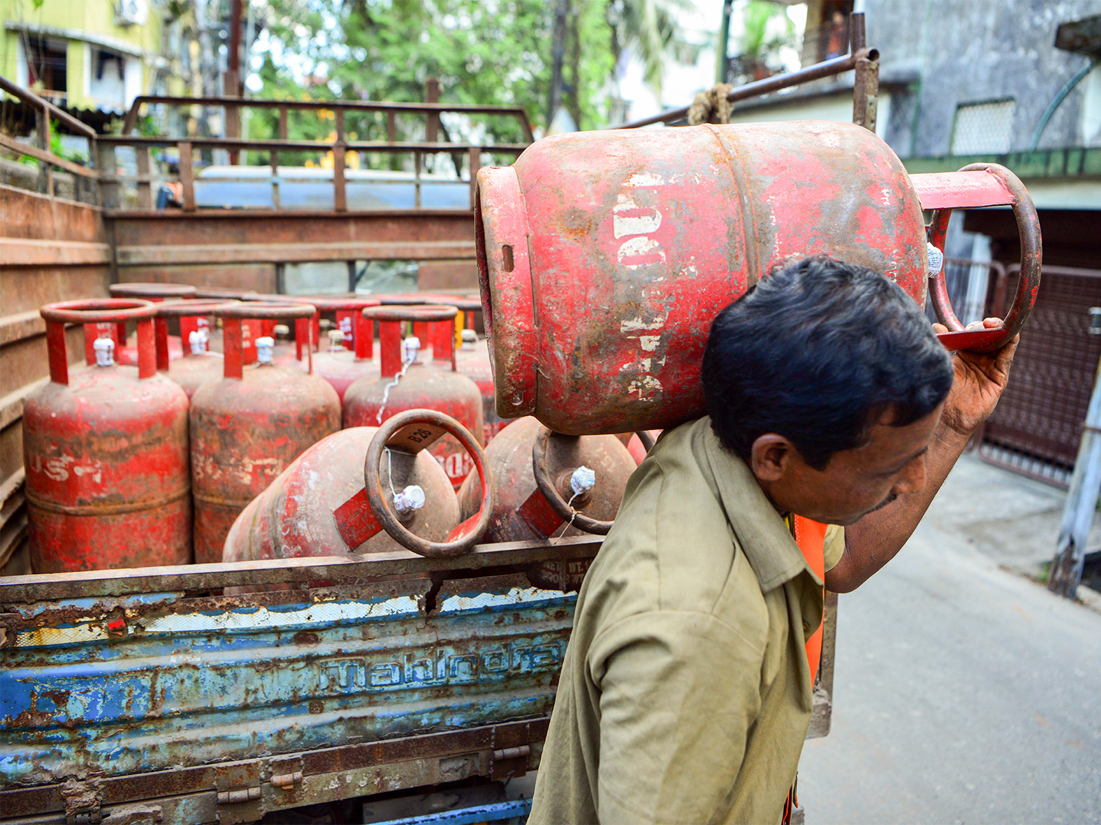 A worker carries an LPG cylinder (File Photo/ANI)