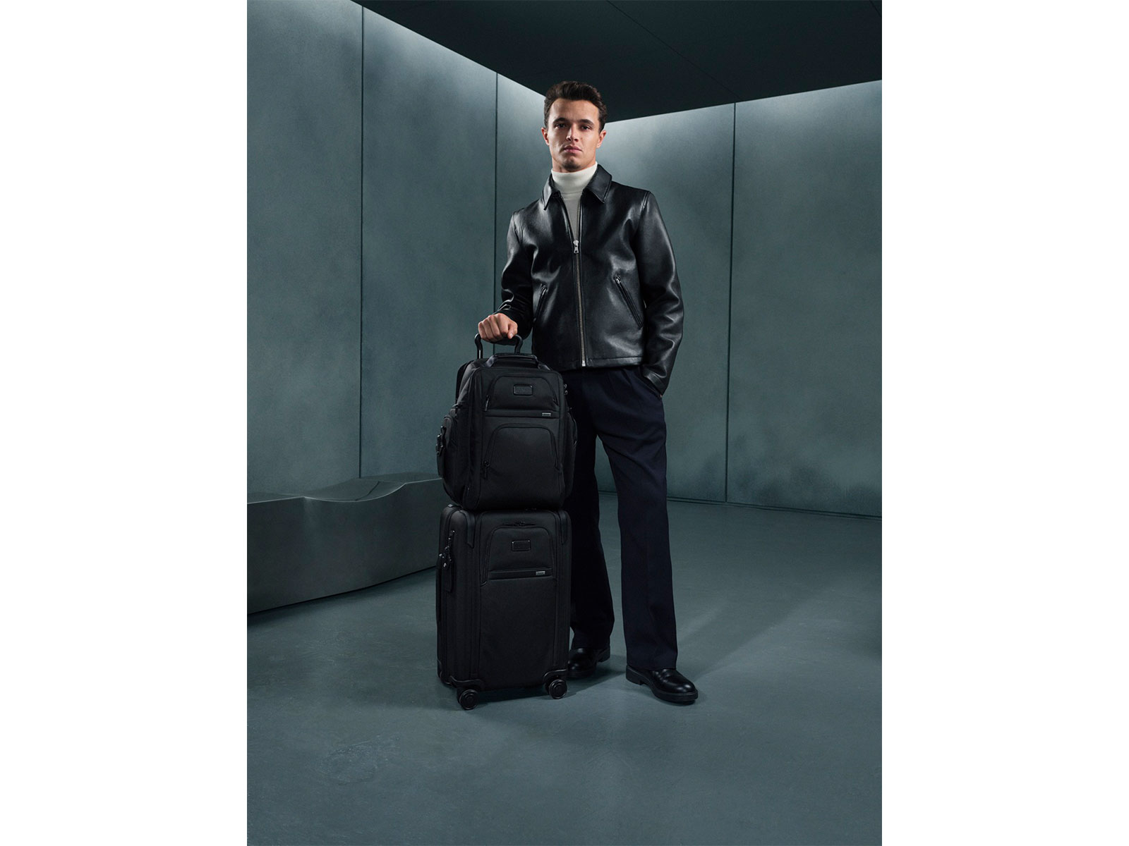 TUMI Global Brand Ambassador and Formula 1 World Champion Lando Norris pictured with Alpha 4 Brief Pack and Alpha 4 Dual Access Expandable Carry-On