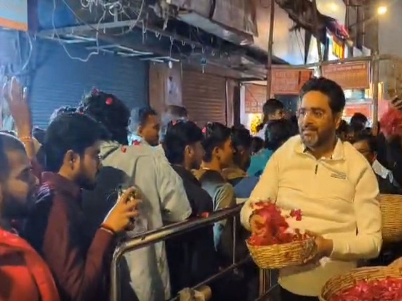 Petals being showered on devotees by Shri Kashi Vishwanath Temple Trust CEO (Photo: ANI)