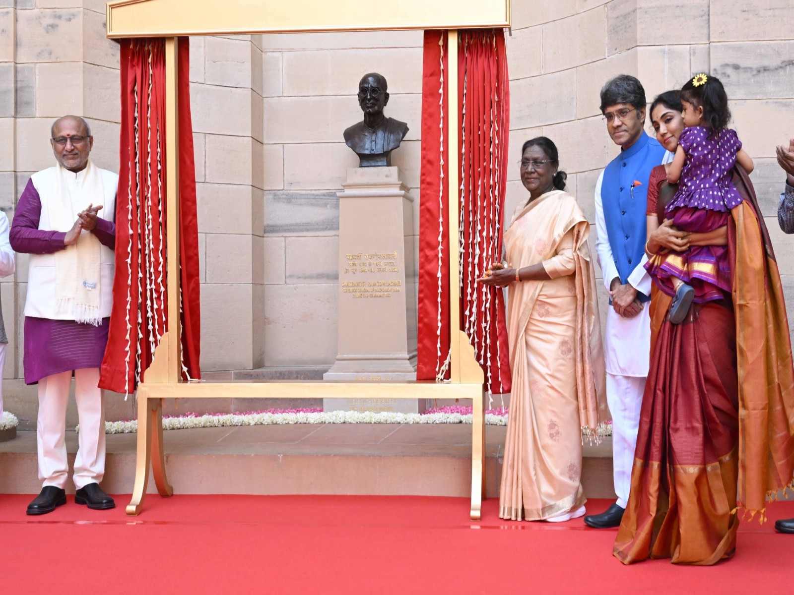 President Droupadi Murmu and VP Radhakrishnan nearby the bust of C Rajagopalachari (Photo/X @rashtrapatibhvn)