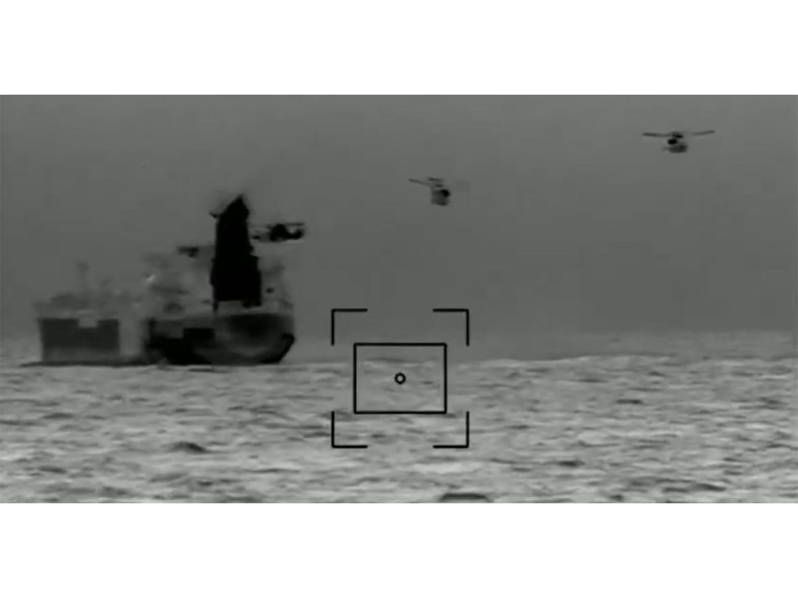 A French Navy helicopter hovers over the 
