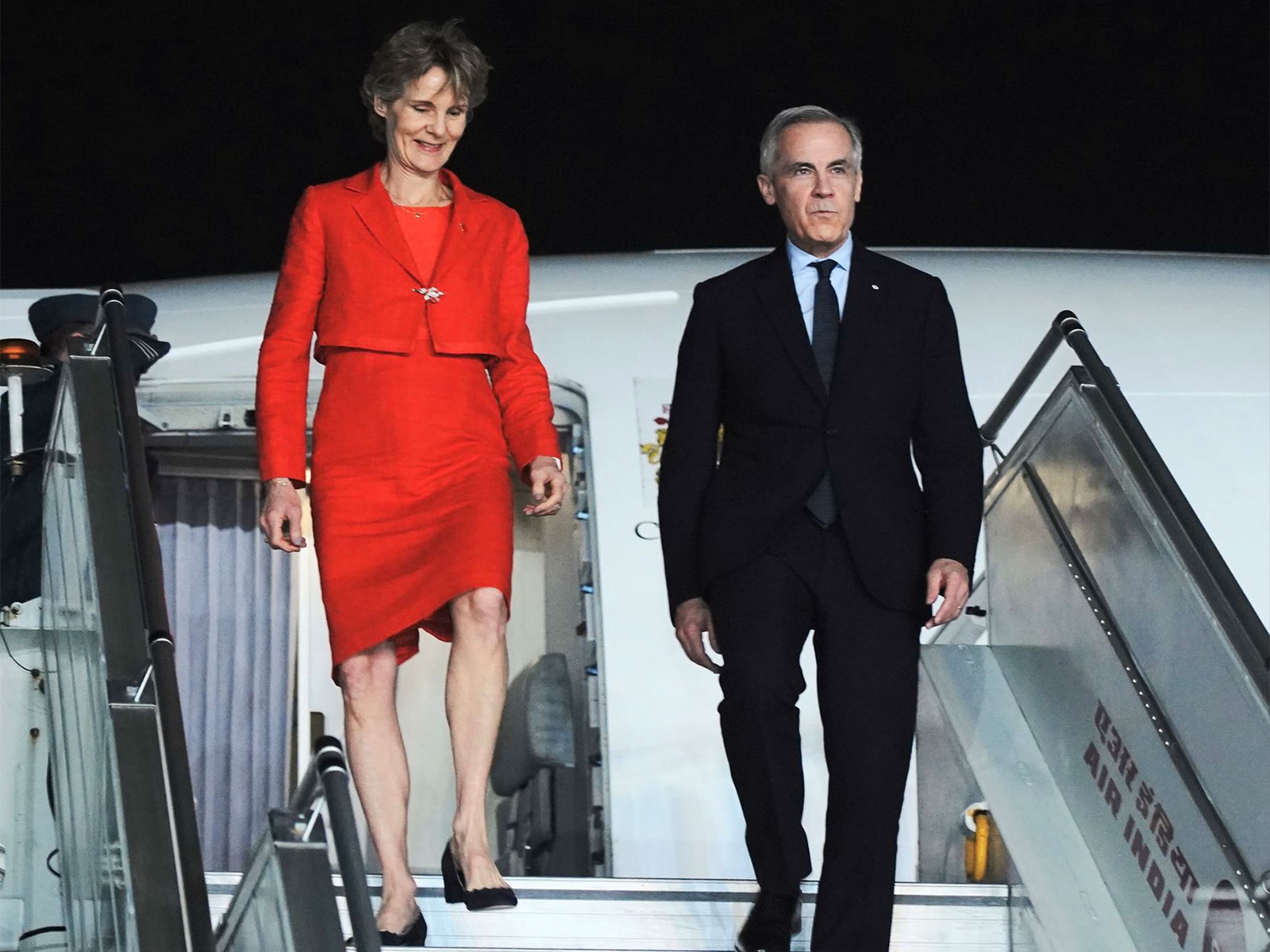 Canadian Prime Minister Mark Carney and his spouse disembark from the aircraft upon arrival in New Delhi during his official visit to India. (Photo: X/@MEAIndia)