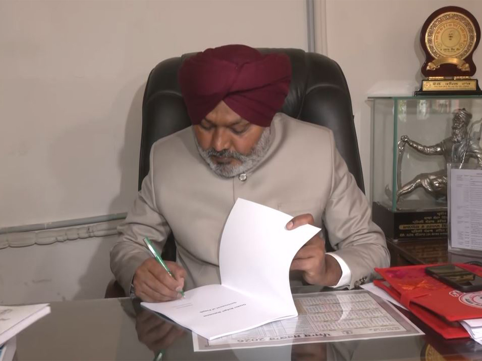 Punjab Finance Minister Harpal Singh Cheema signing budget copy ahead of Punjab Legislative Assembly Budget Session. (Photo/ANI)