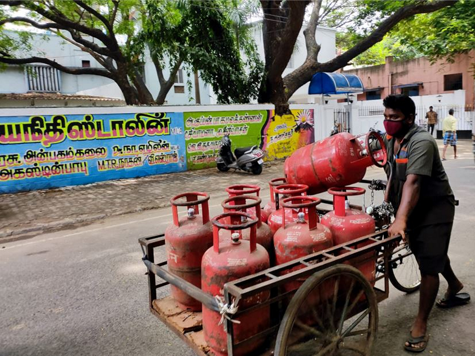 A File photo of a delivery man pushes a cart with gas cylinders at Nungambakkam in Chennai, Tamil Nadu (Photo/ANI)