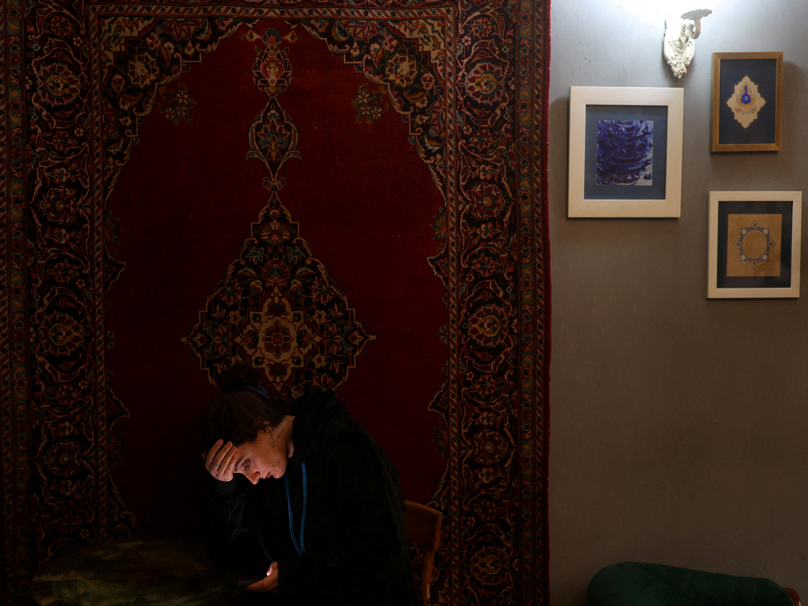 An Iranian woman tries to connect to the internet to check on her visa status for her migration process, after a nationwide internet shutdown (Photo/Reuters)