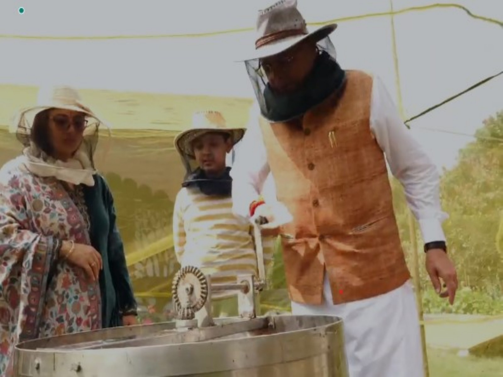 Uttarakhand CM Dhami overseeing honey extraction process (Photo/ANI)