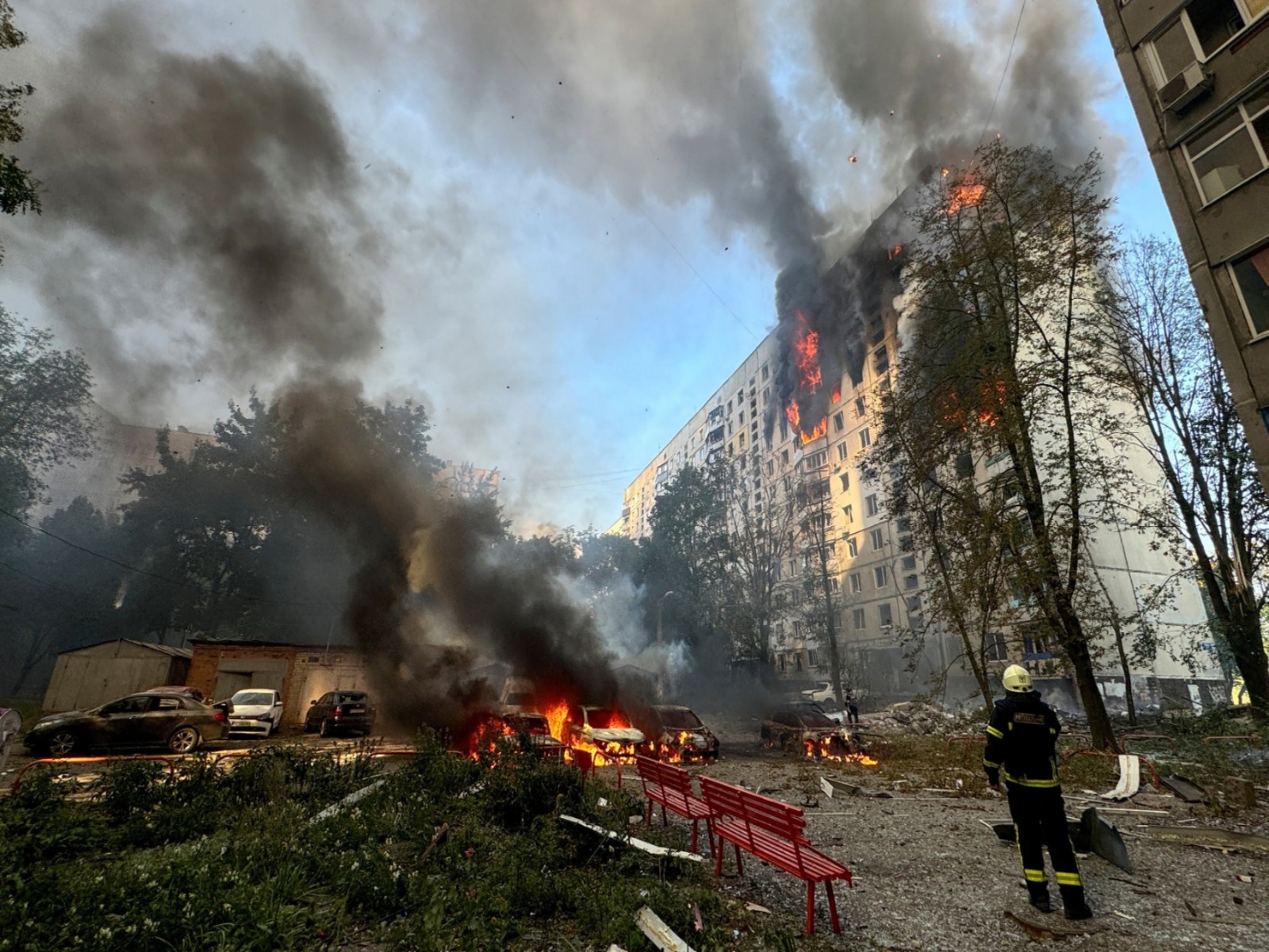 A firefighter looks at an apartment building and cars which burn after a Russian air strike (REUTERS/ANI Photo) A firefighter looks at an apartment building and cars which burn after a Russian air strike (REUTERS/ANI Photo)