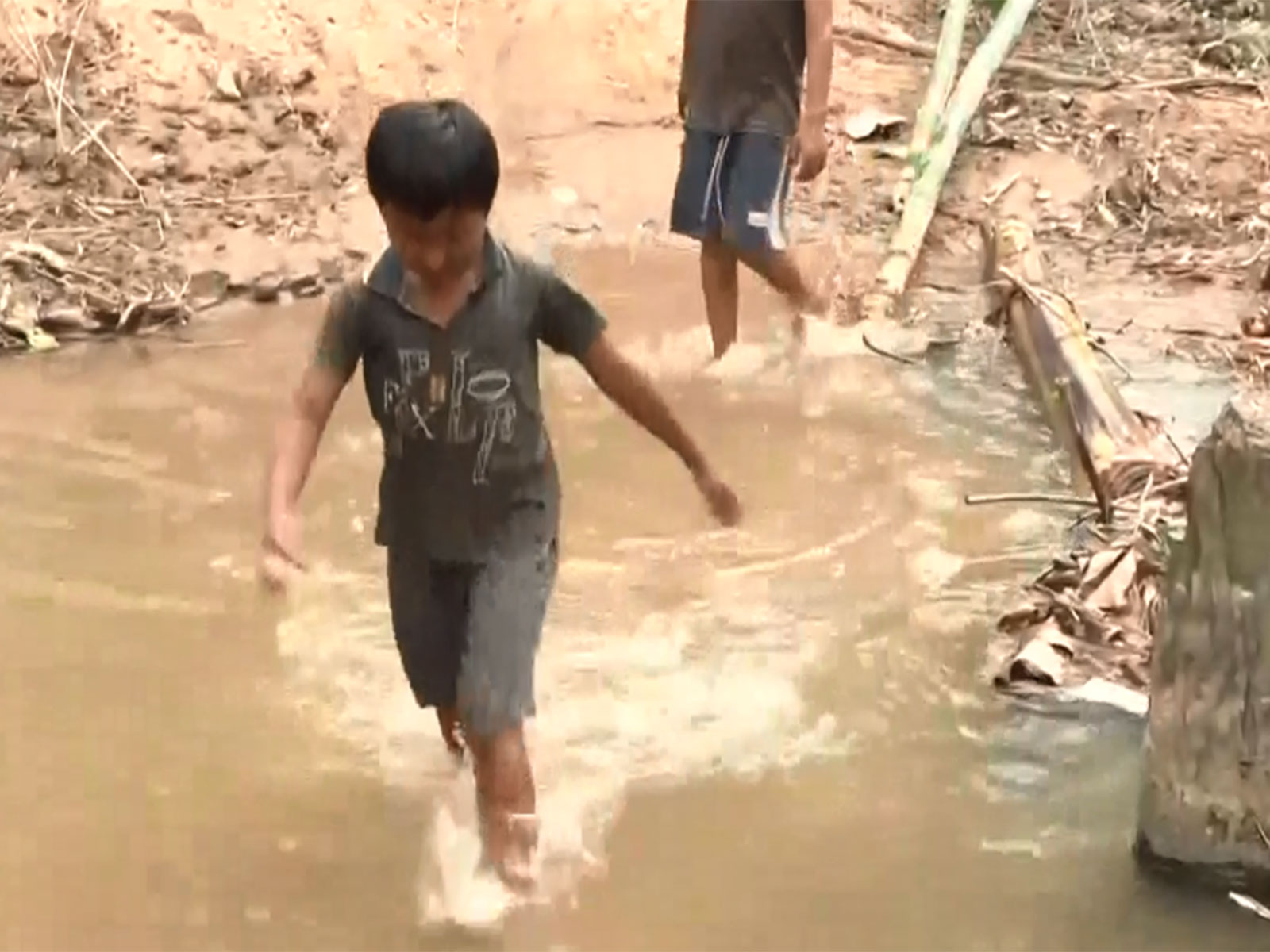 Students crossing Soitai River (Photo/ANI)