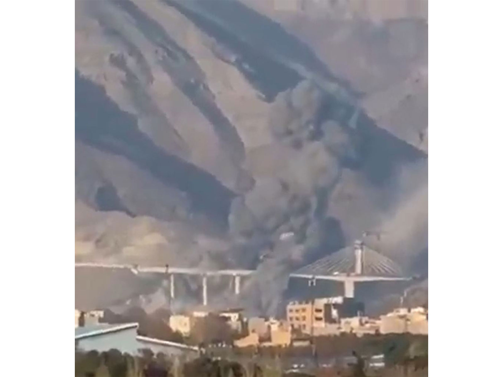 Smoke rises near Karaj’s B1 bridge following reported strikes that caused civilian casualties and damage in the surrounding area. (Image Source: Iranian state media) Smoke rises near Karaj’s B1 bridge following reported strikes that caused civilian casualties and damage in the surrounding area. (Image Source: Iranian state media)