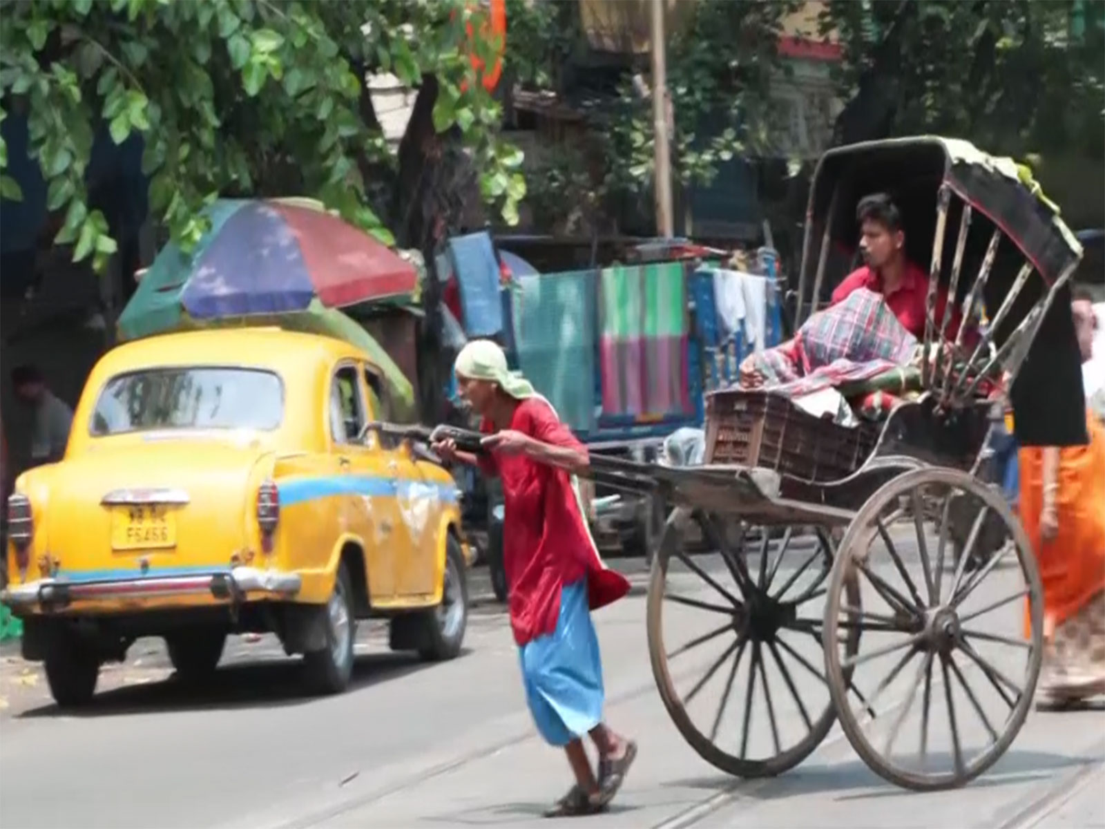 A man pulling hand-pulled rickshaw on a street of Kolkata. (Photo/ANI)