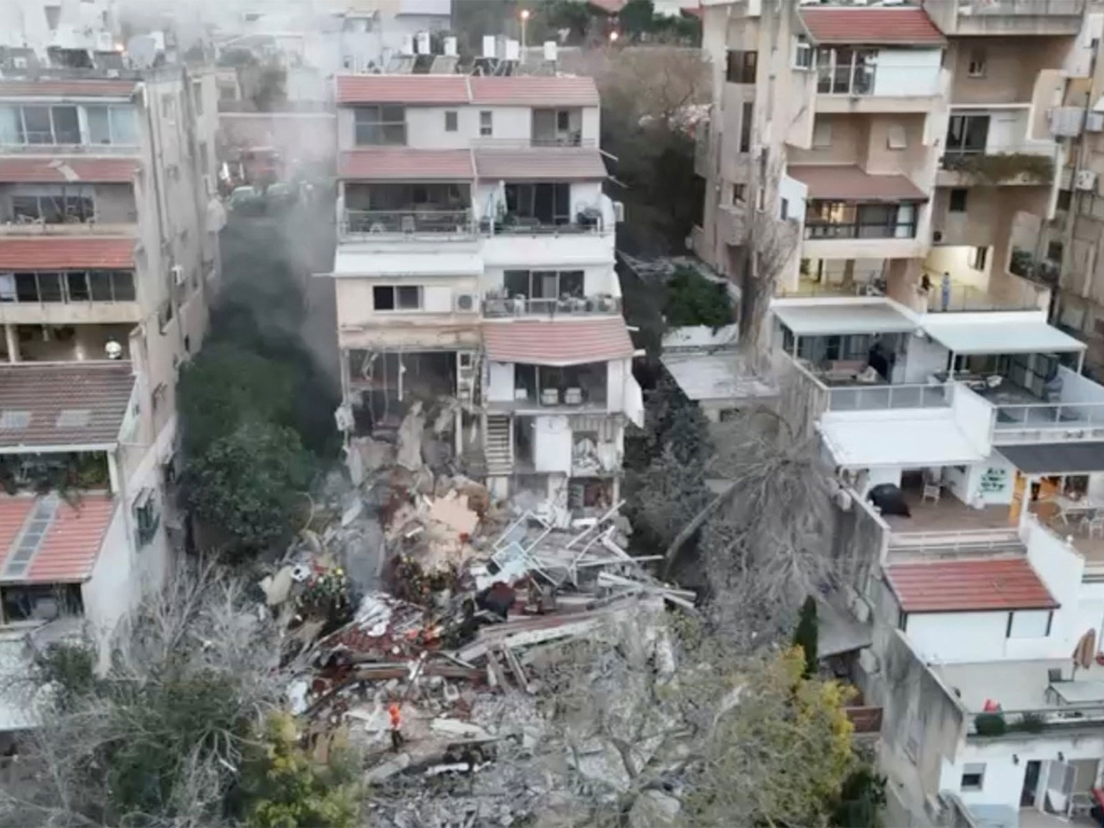 Emergency personnel work at the site following a reported Iranian missile strike in Haifa (Photo/ Reuters via MDA)