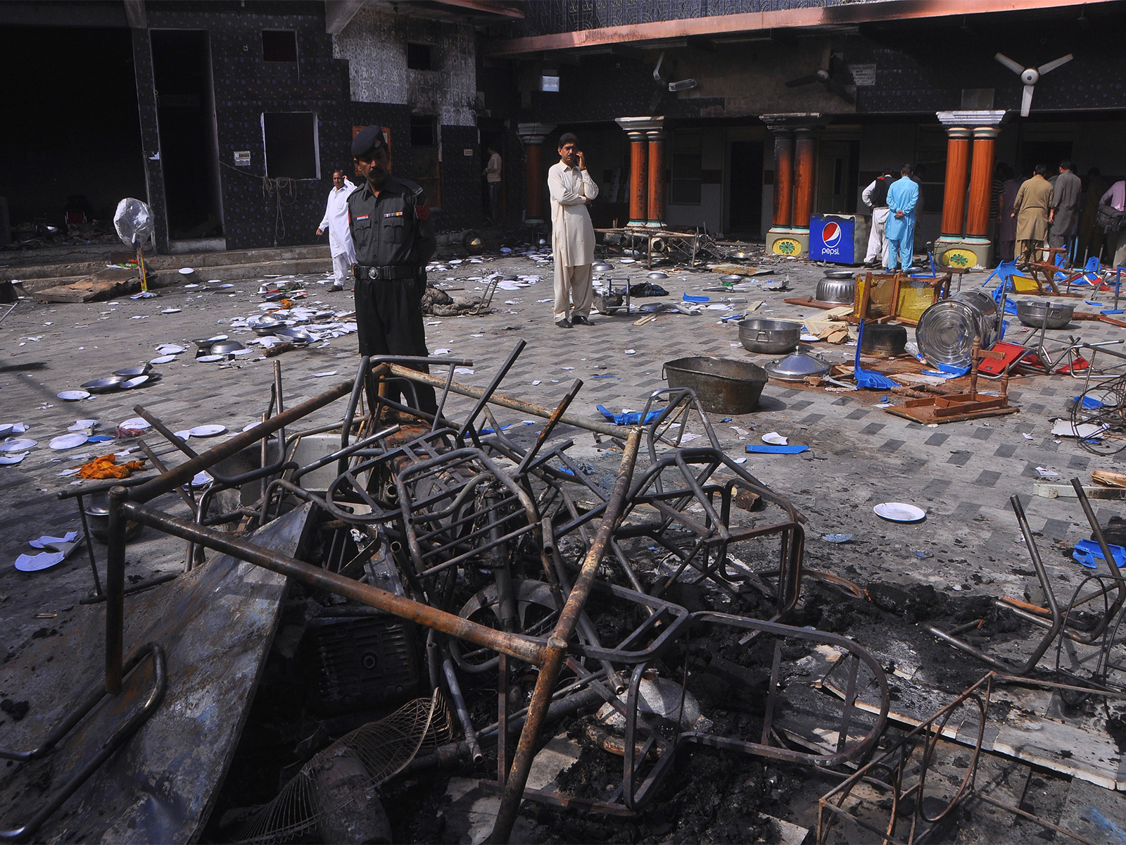 A security official and members of Hindu community stand inside a temple that was attacked in Larkana, Pakistan (File photo/ Reuters)