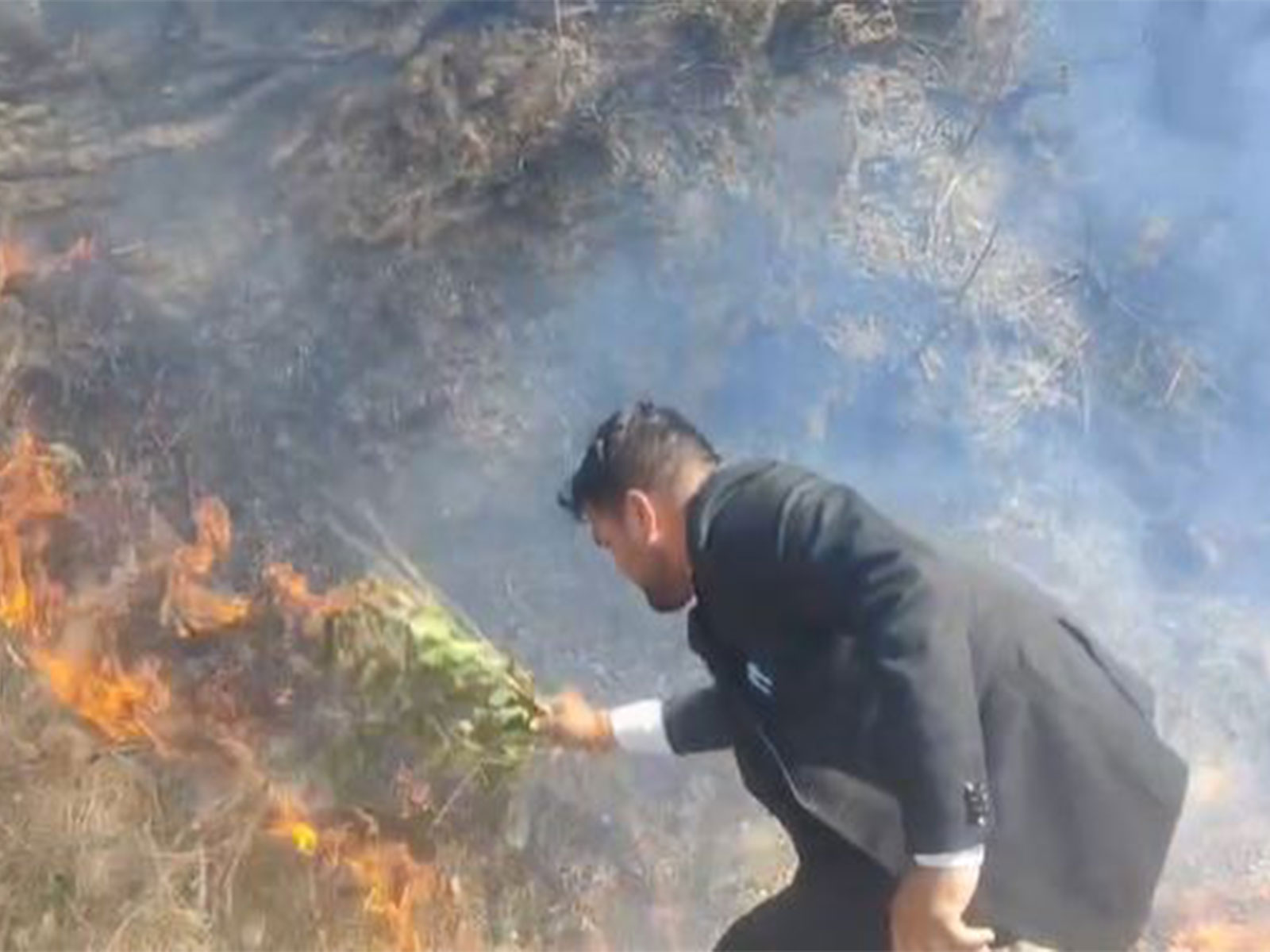 Local residents attempt to douse the forest fire as it spreads across the area (Photo/ANI)