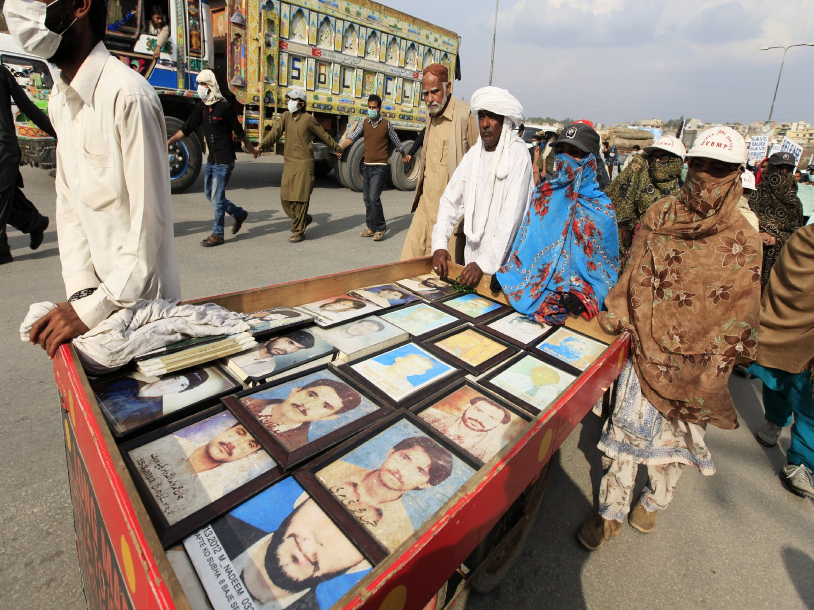 Relatives display pictures of people who have gone missing in Balochistan (File Photo/Reuters)