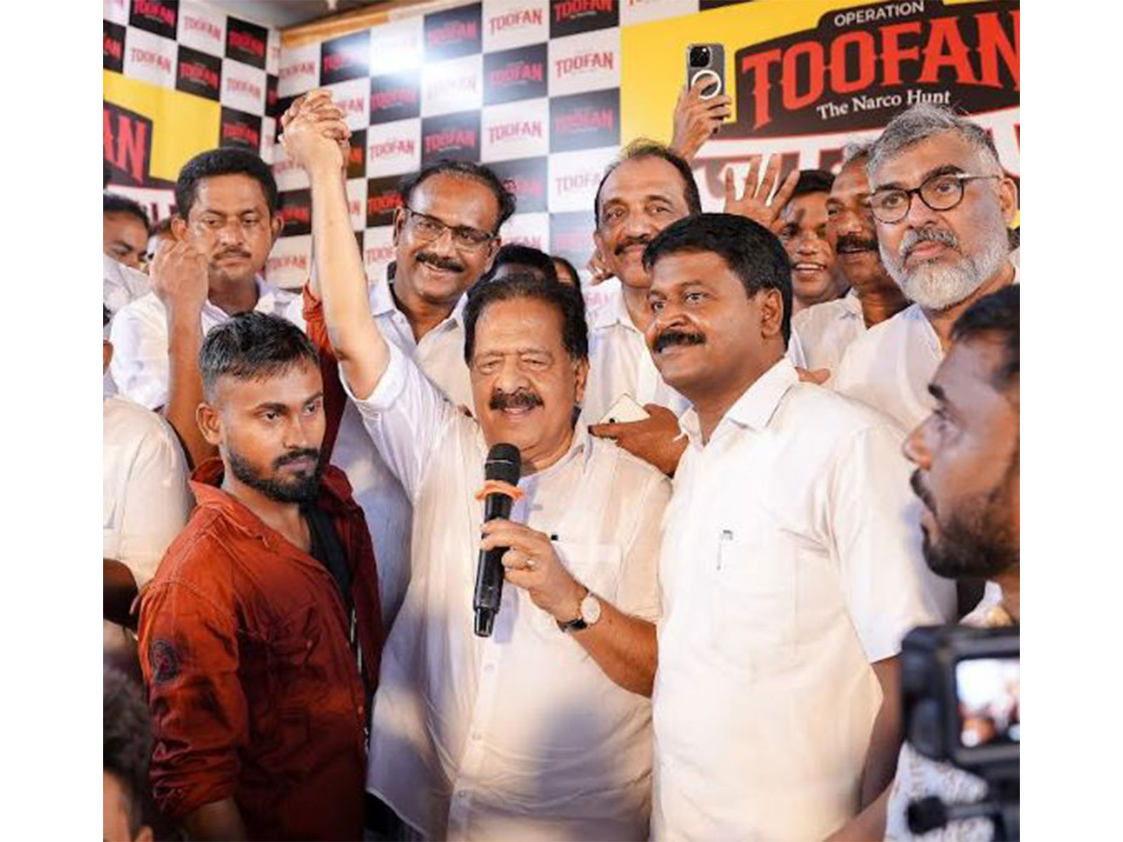 Kerala Home Minister Ramesh Chennnithala holding up the hand of a migrant labourer at Kandanthara Bhai Colony at Perumbavoor. Benny Behanan MP, Manoj Moothedan MLA also seen Kerala Home Minister Ramesh Chennnithala holding up the hand of a migrant labourer at Kandanthara Bhai Colony at Perumbavoor. Benny Behanan MP, Manoj Moothedan MLA also seen