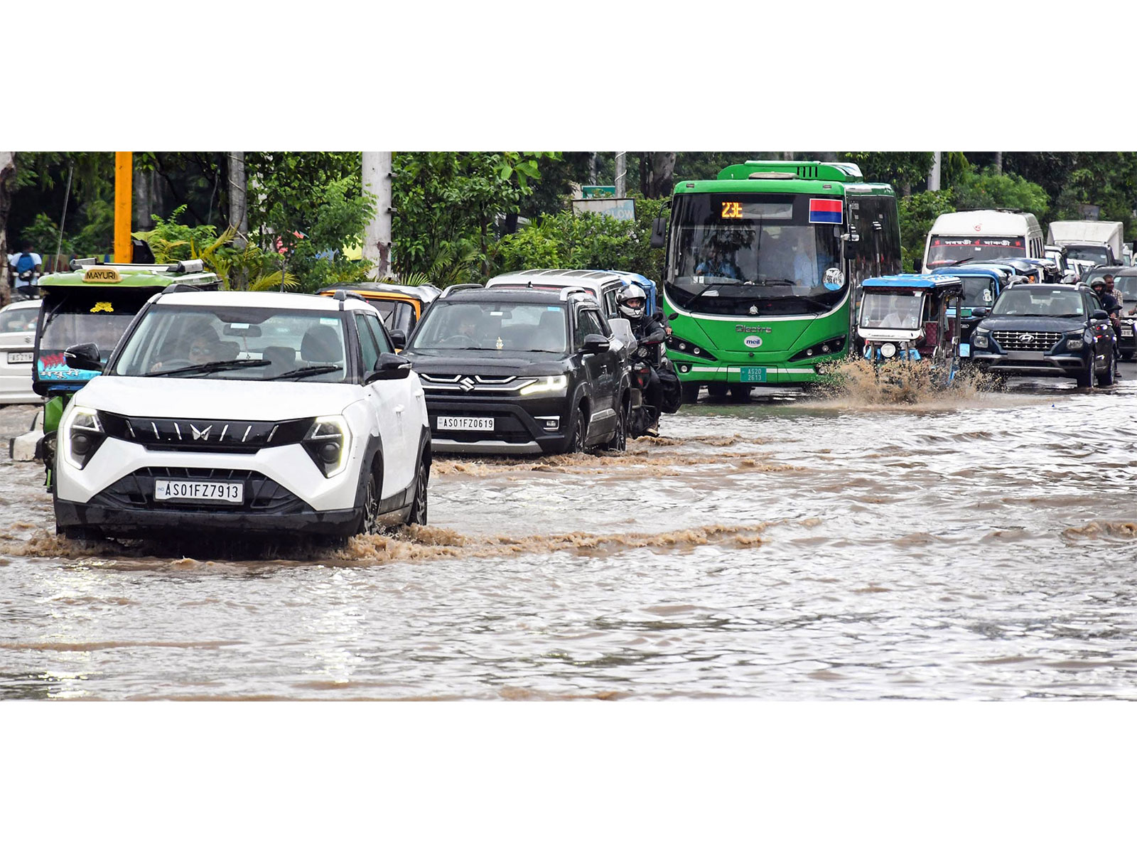 Vehicles wade through a waterlogged road after heavy rainfall in Guwahati (File Photo/ANI)