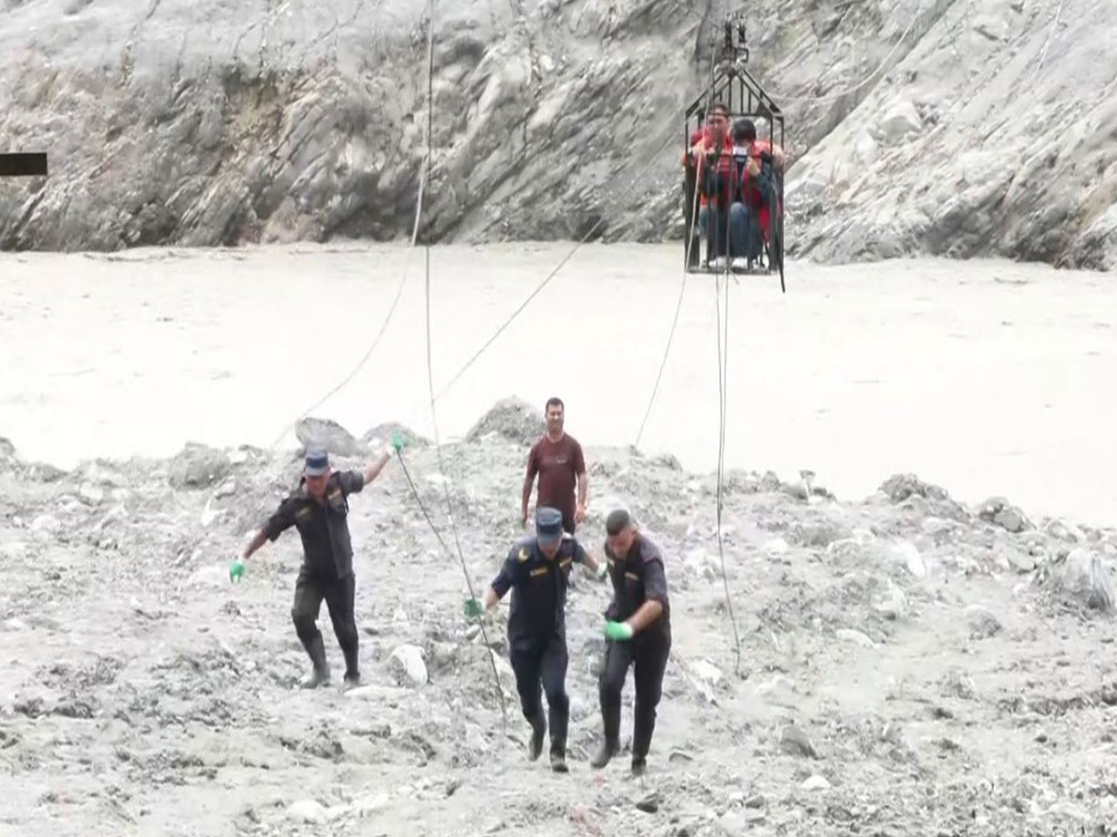 Nepal Police operate makeshift zip line to help residents cross river in flood-hit Trishuli