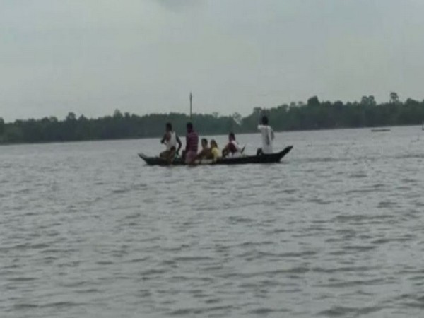 Visuals of villagers shifting to safe places due to flood in Assam on Saturday. Photo/ANI
