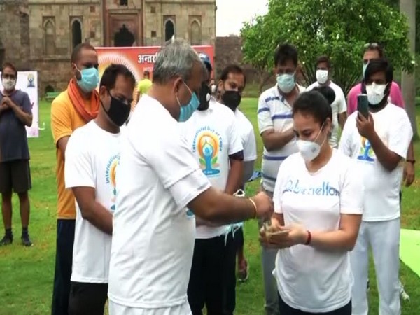 Delhi BJP President Adesh Kumar Gupta distributing masks and sanitisers to people on International Yoga Day in New Delhi on Sunday. [Photo/ANI]