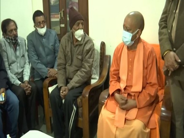 UP CM Yogi Adityanath meeting family members of Wing Commander Prithvi Singh Chauhan (Photo/ANI)