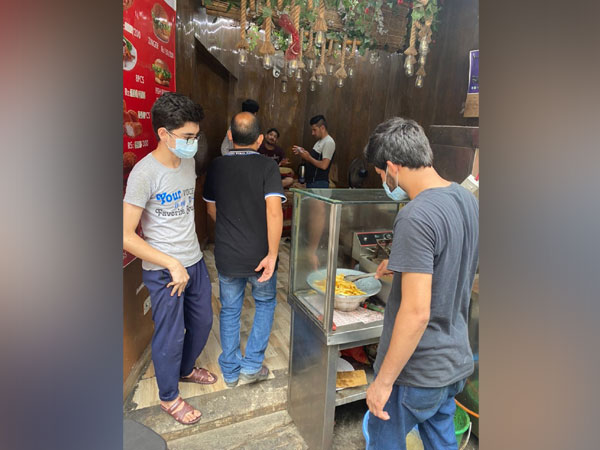 Afghans working in local shops and restaurants. (ANI)