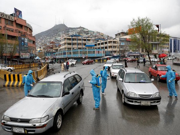 Volunteers spray disinfectants on vehicles amid coronavirus concerns in Kabul
