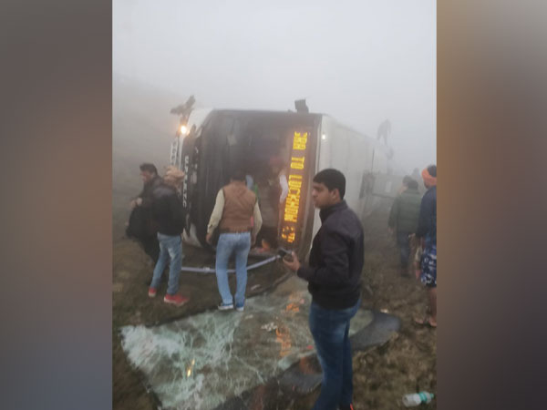 The bus which rolled over on Agra-Lucknow Expressway near Fatehabad in Agra district on Monday morning. Photo/ANI