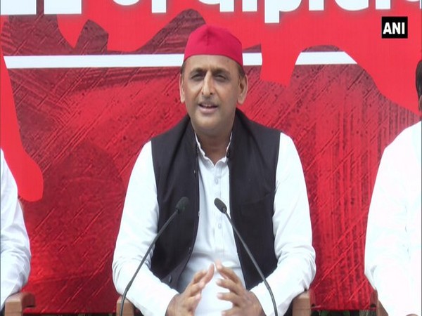    Samajwadi Party leader Akhilesh Yadav speaking with reporters in Etawah, Uttar Pradesh.