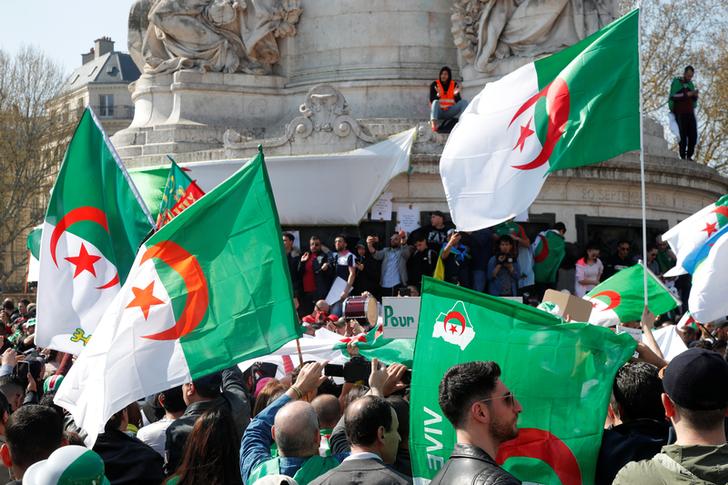 Protesters carry Algerian flags demand the removal of Abdelaziz Bouteflika as President in Algiers on April 5.