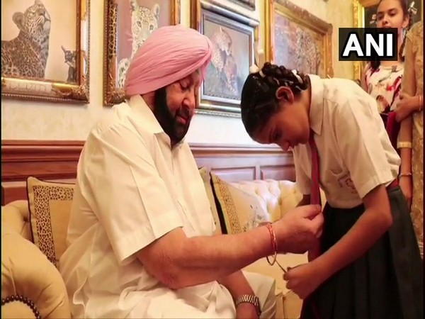 A child tying rakhi on Punjab Chief Minister Captain Amarinder Singh in Jalandhar on Thursday. Photo/ANI