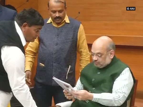BJP president Amit Shah accepting bio-data from a ticket seeker at the party headquarters in New Delhi on Thursday. Photo/ANI