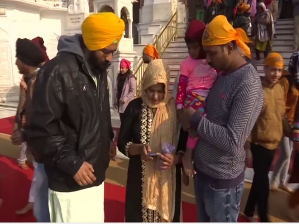 A volunteer asks visitors to delete the videos and pictures taken inside Golden Temple premises from their devices. Photo/ANI