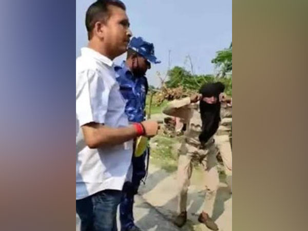 Araria District Agricultural officer Manoj Kumar (in white shirt) in the video grab wherein a security guard is being made to do sit-ups. Photo/ANI