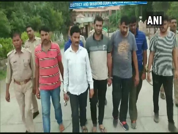 Police with arrested people in Noida on Monday. Photo/ANI