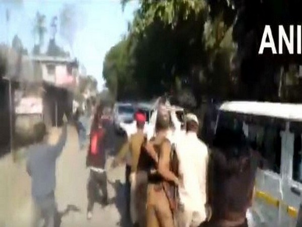 Police try to stop AASU workers from showing flags to CM's convoy in Dibrugarh Photo/ANI