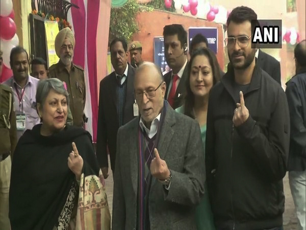 Anil Baijal with wife caste vote at a polling booth in GK [Photo/ANI]