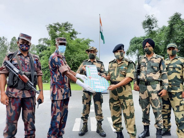 BSF-BGB jawans exchange sweets at Border on Eid al-Adha. (Photo/ANI)