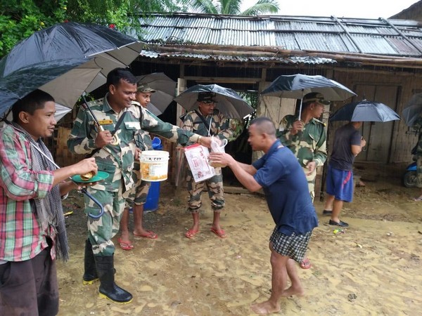 BSF personnel distributing relief material in Mizoram. Photo/ANI