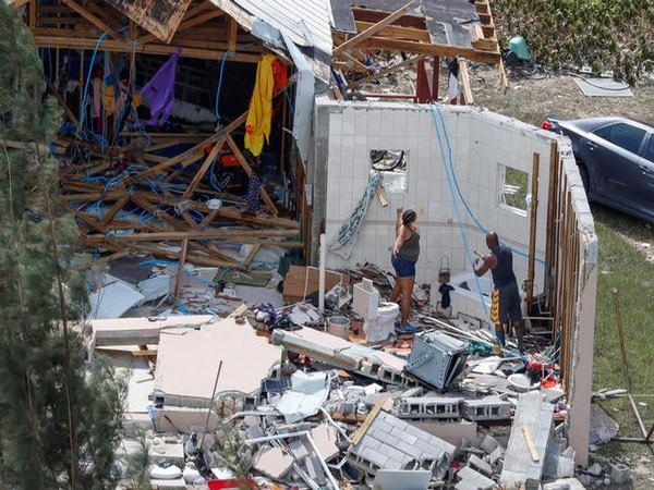Residents look for their belongings in Grand Bahama on Wednesday after Hurricane Dorian ravaged the Bahamas earlier this week. (Photo Credits: Reuters)