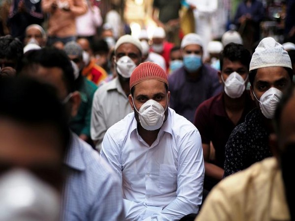 Muslims wear protective face masks following the coronavirus outbreak, as they pray on street during Friday prayers in local souq, in Manama