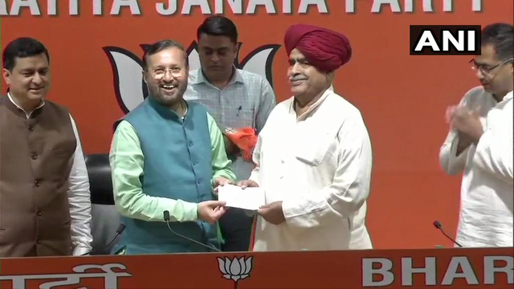 Union Minister Prakash Javadekar (left) with Gujjar leader Kirori Singh Bainsla (right) in New Delhi on Wednesday.