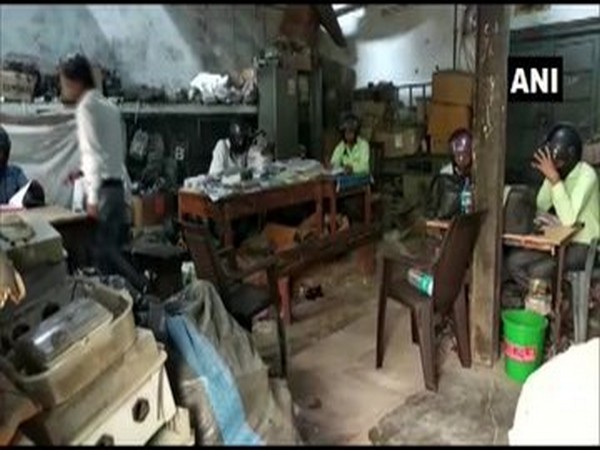 Employees wearing helmets in office in Banda. 