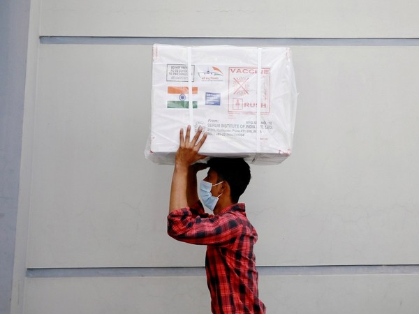 A worker carrying Oxford-AstraZeneca vaccine received as as a gift from India to Bangladesh (Photo Credit - Reuters)
