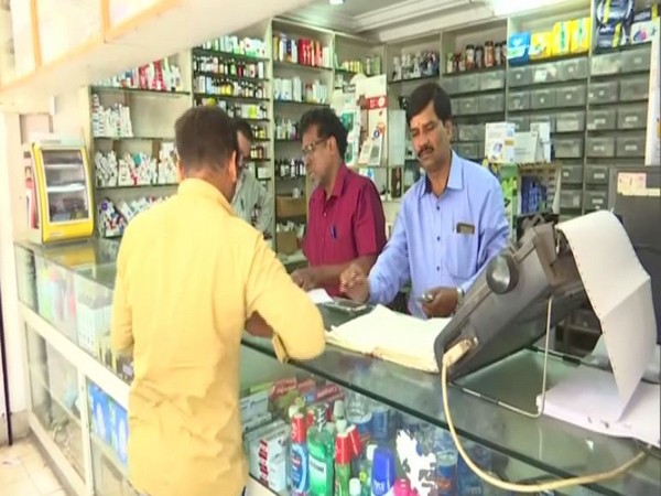Man buys mask from a chemist shop in Bengaluru Photo/ANI