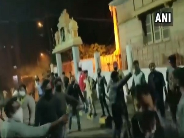 Screengrab of the video which shows Muslim youth forming human chain outside temple on Tuesday night.