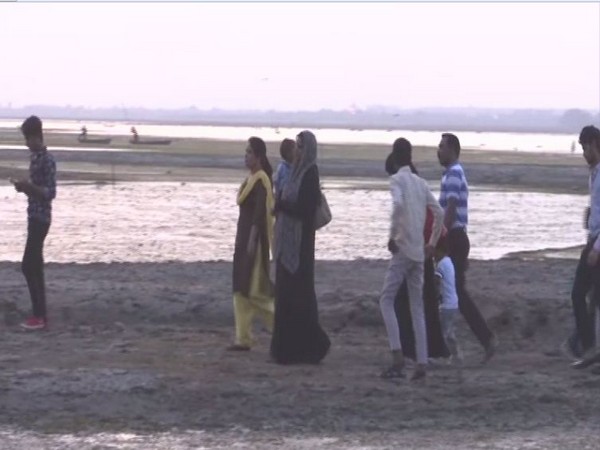 People walk on the bed of the lake in Bhopal (Photo/ANI)