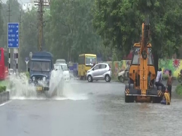 Vehicles wading through a waterlogged street in Bhopal on Monday. Photo/ANI