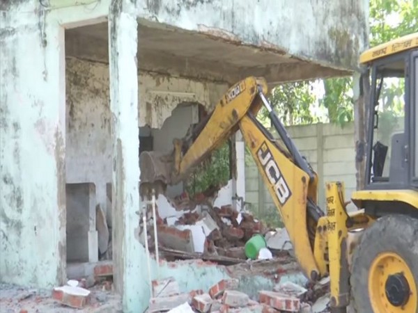 A bulldozer in action at Congress MLA Arif Masood's property in Bhopal. [Photo/ANI]