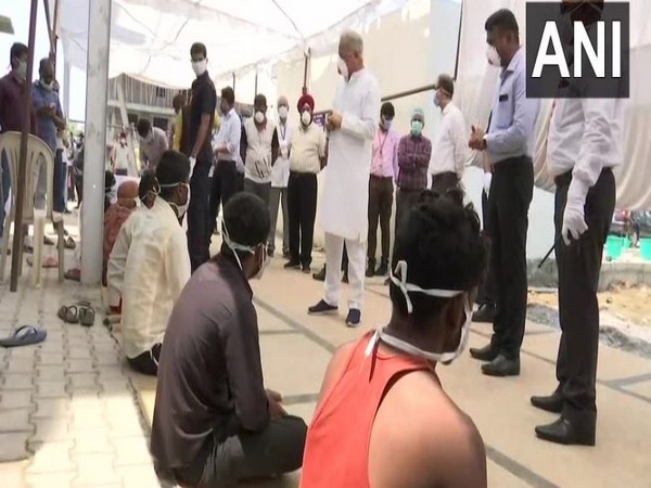 Chhattisgarh Chief Minister Bhupesh Baghel interacting with the migrant workers at a shelter home on Wednesday. Photo/ANI